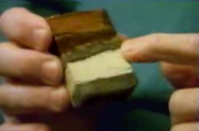 Alvarez holding the piece of clay which sparked research into the impact theory. The second green band from the bottom is extremely high in iridium.
